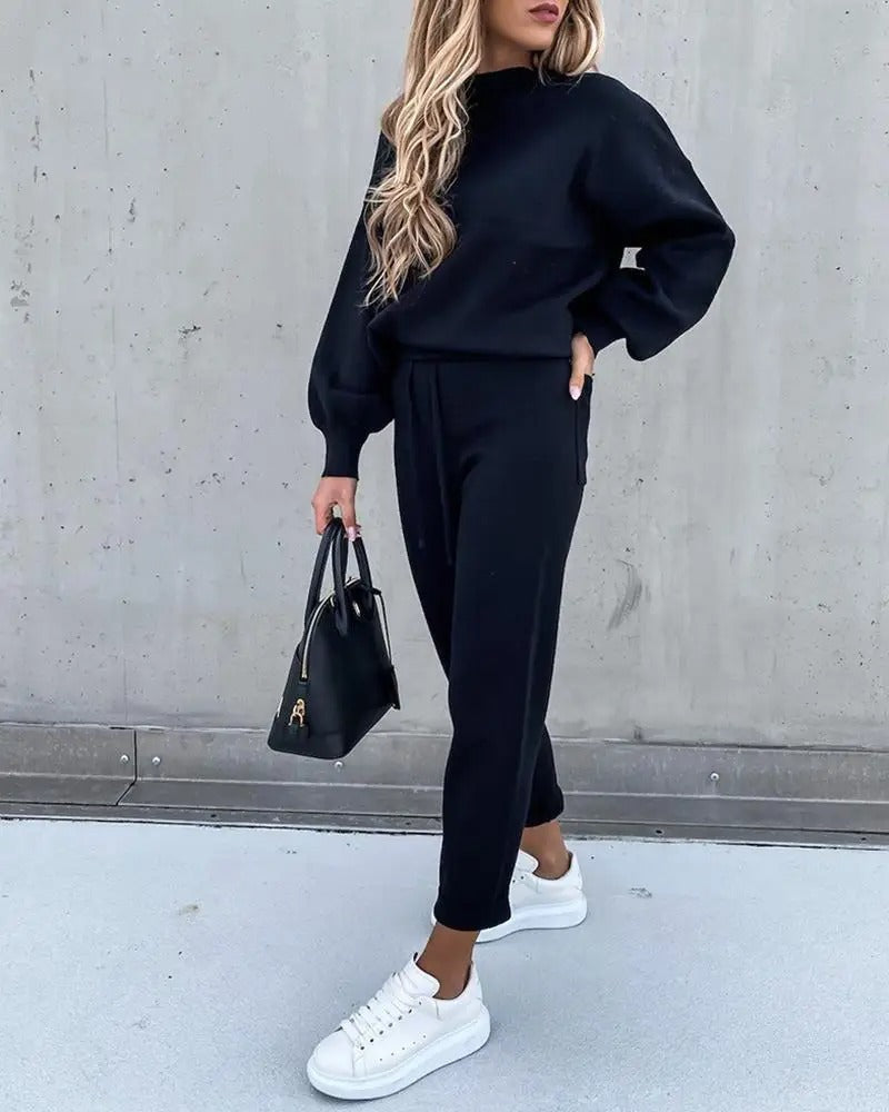 Woman modeling comfortable premium tracksuit, a stylish 2-piece lounge suit for all-day wear.