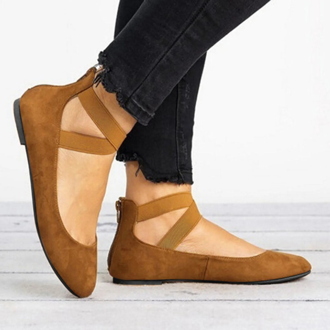 Fashionable women's ballet flats with unique cross straps, ideal for a casual chic or work-appropriate look.