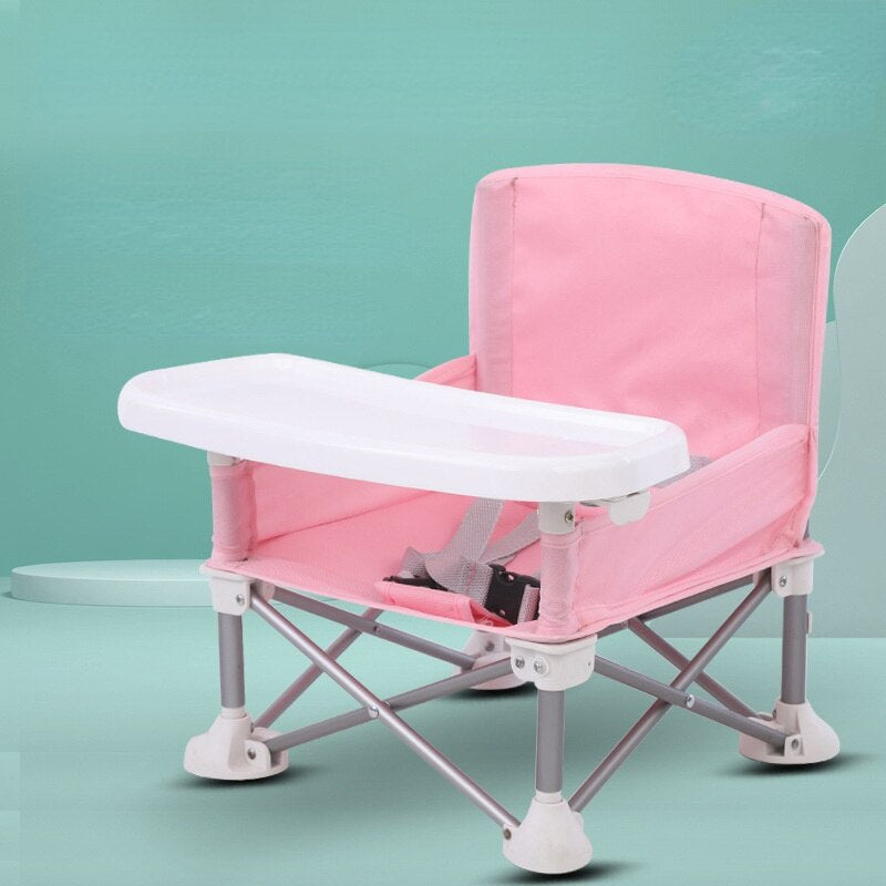 Lightweight portable kids' chair with safety harness & built-in activity tray for outdoor fun.