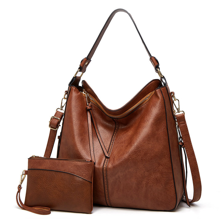 Women's elegant black leather shoulder bag, spacious & versatile for everyday fashion.