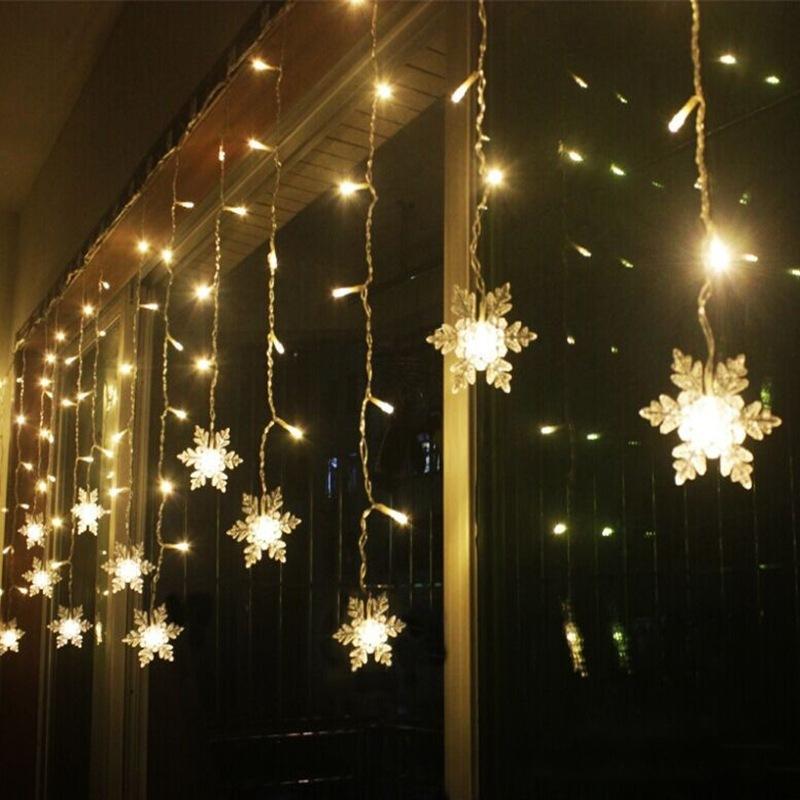 Weatherproof LED snowflake fairy lights, perfect for outdoor winter holiday ambiance.