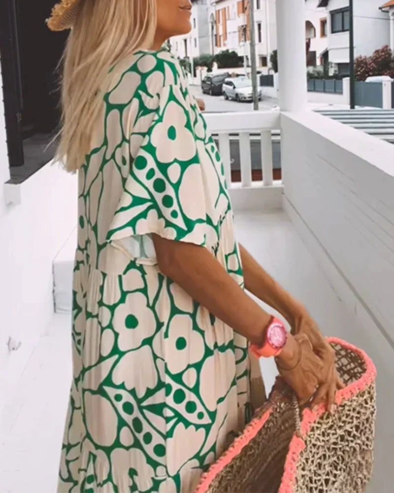 Close-up of the fabric detail on a women's elegant flowy short-sleeve summer maxi dress.