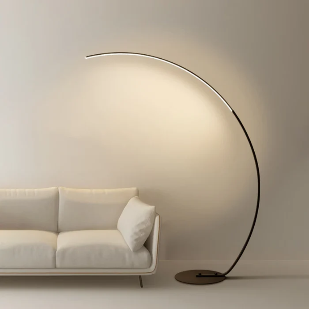Sleek modern LED floor lamp next to a sofa in a living room. Perfect contemporary accent lighting, minimalist design.