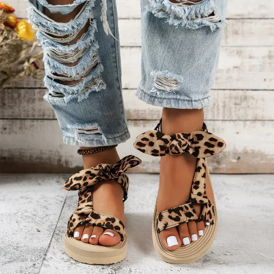 Stylish women's leopard print flat sandals, perfect comfortable summer shoes with a chic animal print.