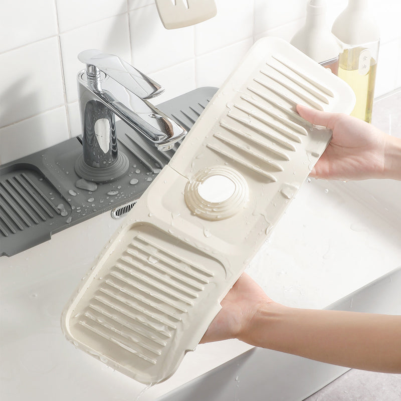 Self-draining silicone mat for kitchen sink, keeps countertops dry & organized.