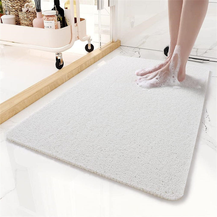Anti-slip shower mat with hollow drainage design, providing secure footing and quick drying for home safety.