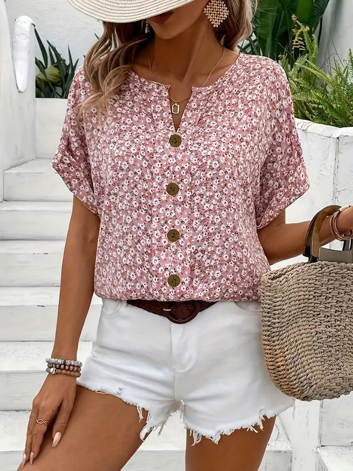 Chic women's floral print blouse with elegant button detail, perfect for office or everyday summer wear.