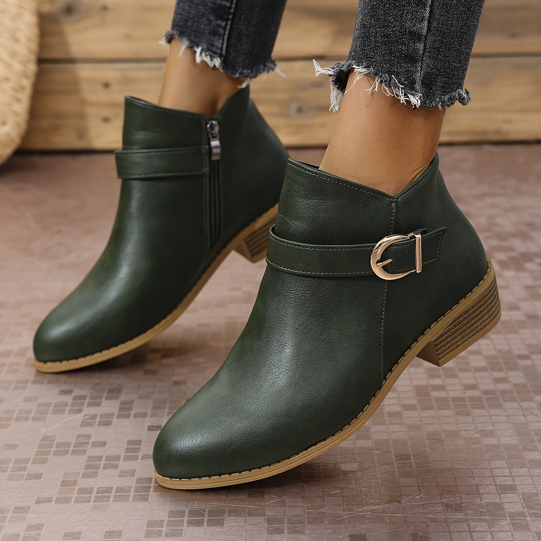 Green women's fashion Chelsea ankle boots featuring a modern buckle, low block heel, and practical side zip.
