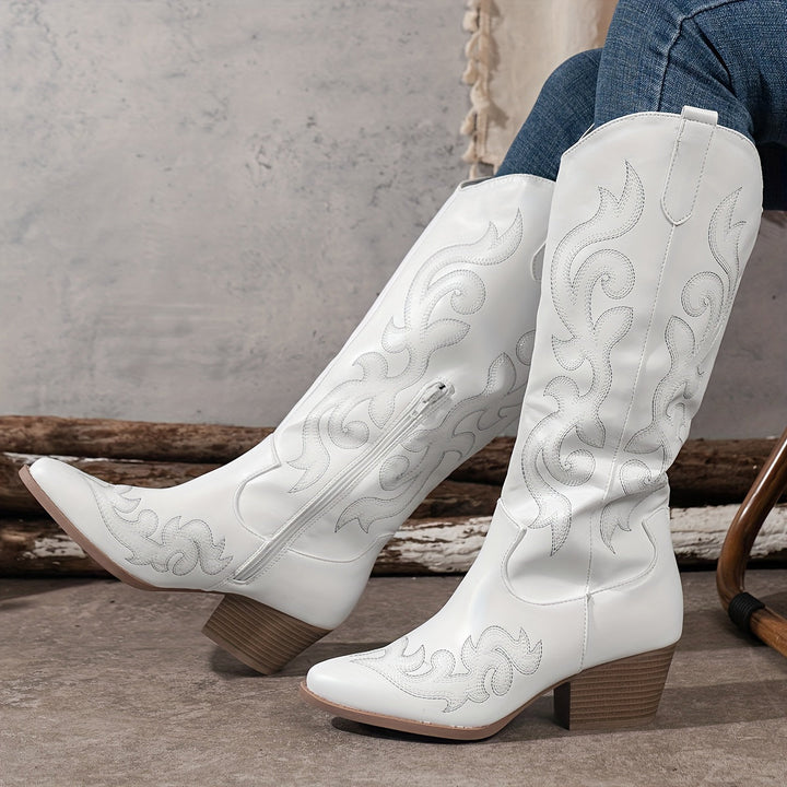 Elegant women's knee high cowboy boots, featuring intricate embroidery and a classic pointed toe.