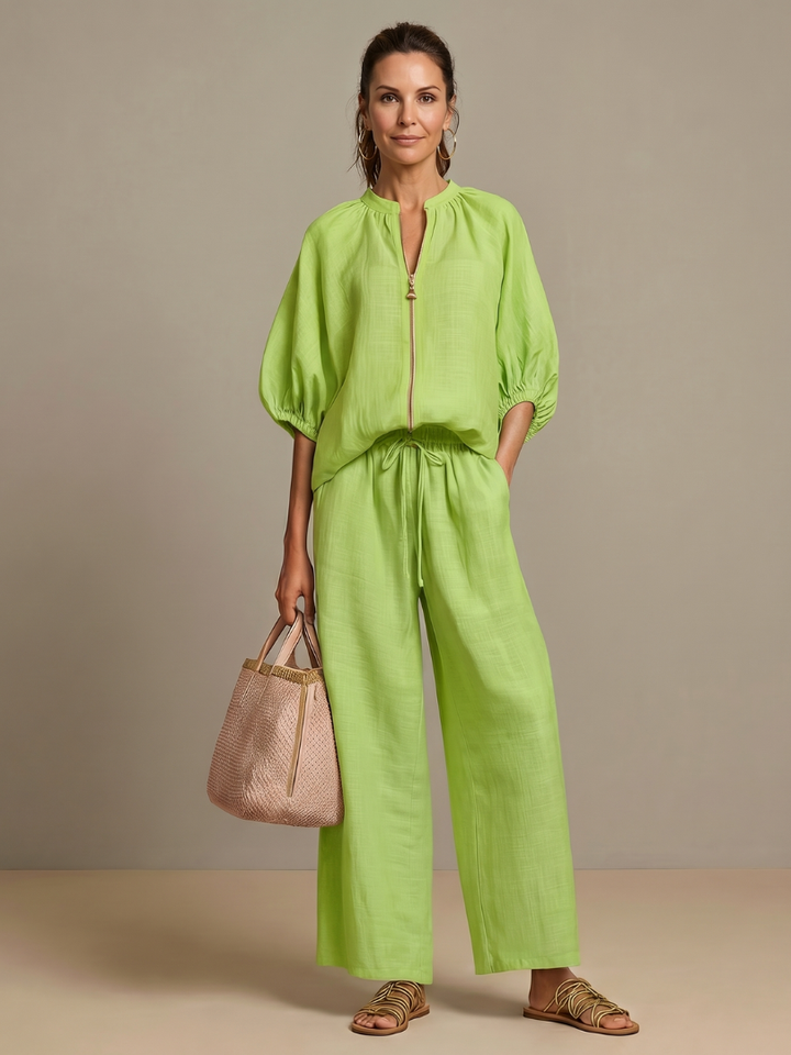 Women's stylish blouson zip-front top, part of a two-piece casual chic set.