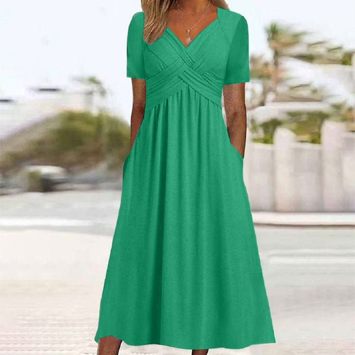Comfortable women's V-neck summer dress with pockets, ideal for a chic, casual or work look.