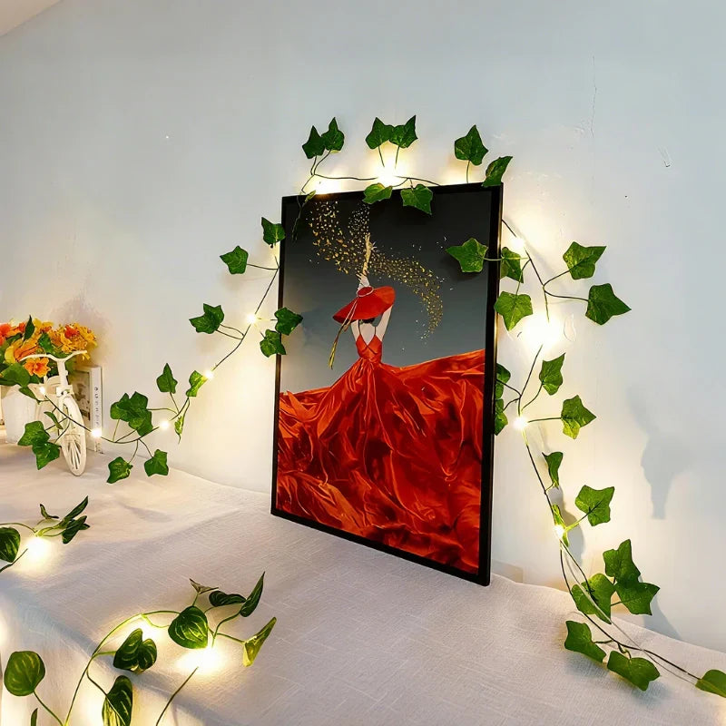 Flexible LED leaf vine lights, warm white, for enchanting holiday or party decor.