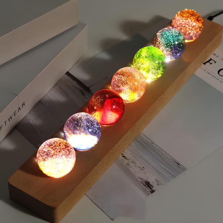 Celestial display galaxy orb set on a sleek wooden LED base, creating a unique crystal light ambiance.