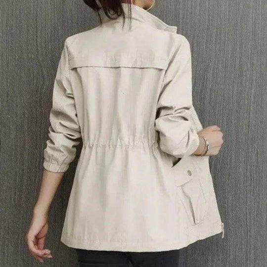 Lightweight women's waterproof rain jacket. Fashionable cinched waist design for ultimate weather protection.