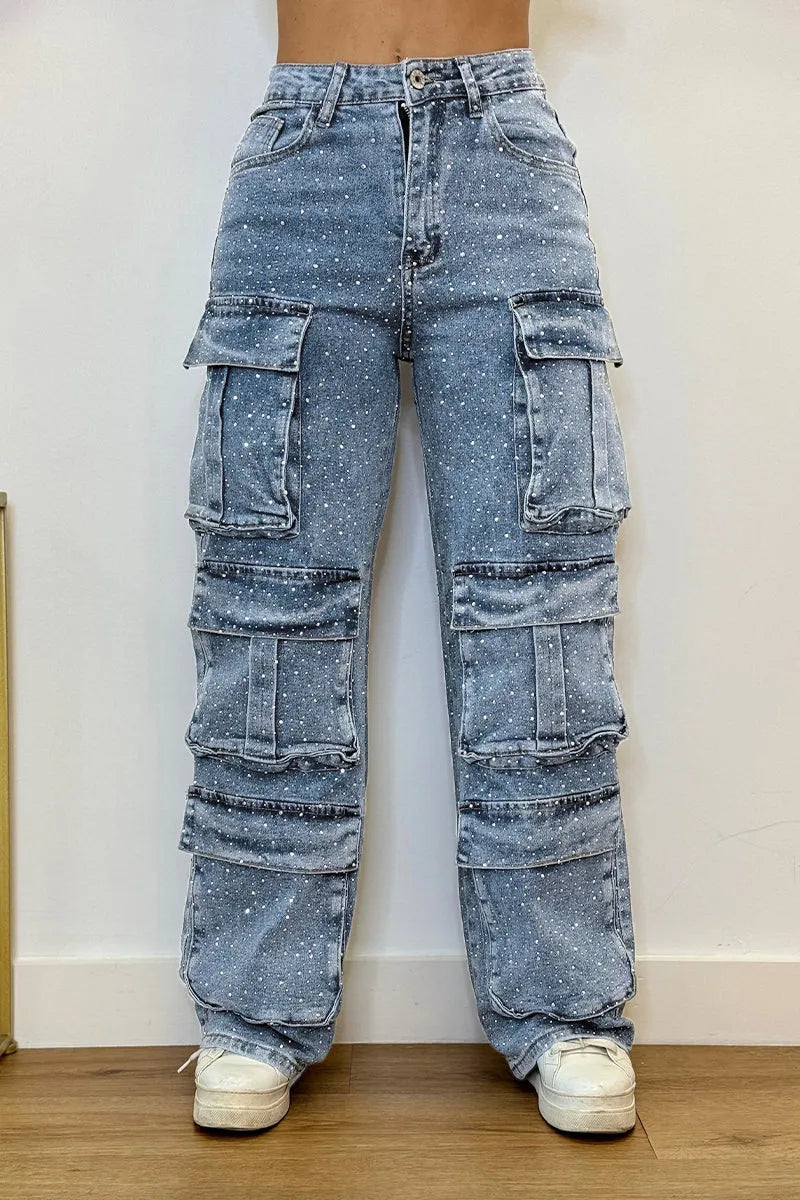 Detail view of pockets on women's cargo jeans adorned with sparkling rhinestones.