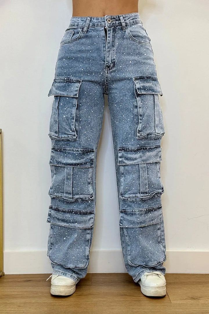 Detail view of pockets on women's cargo jeans adorned with sparkling rhinestones.