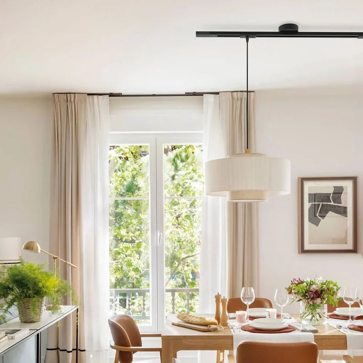Sleek black aluminum pendant light rail, adjustable for dynamic interior illumination.