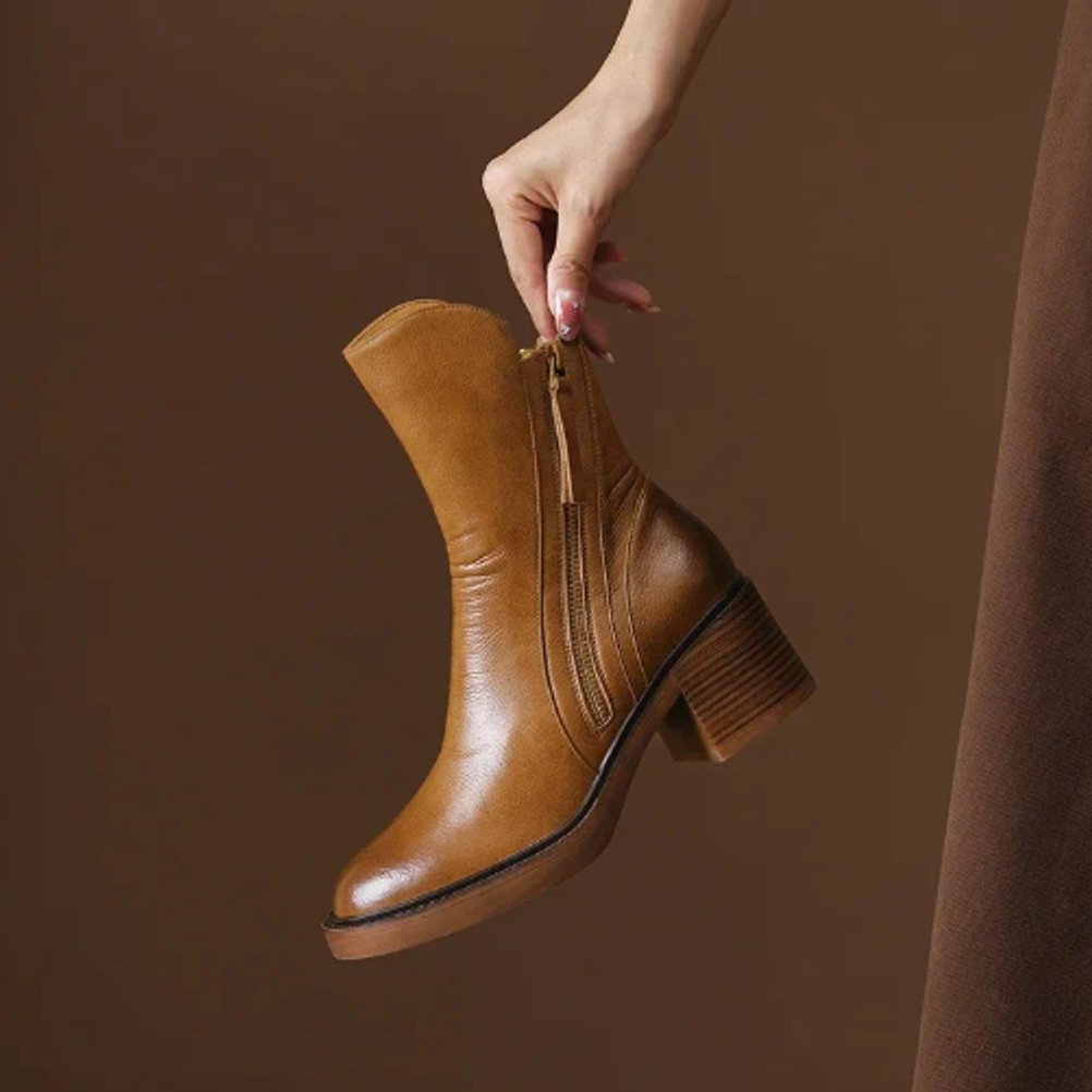 Elegant brown women's ankle boots with a comfortable block heel and practical side zip closure.
