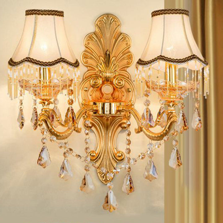 Detailed view of the elegant fabric shade on a gold Victorian wall sconce, highlighting texture & design.