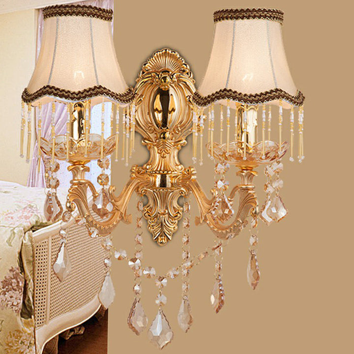 Elegant Victorian gold wall lamp with fabric shade & dazzling crystal decor. Traditional interior lighting fixture.