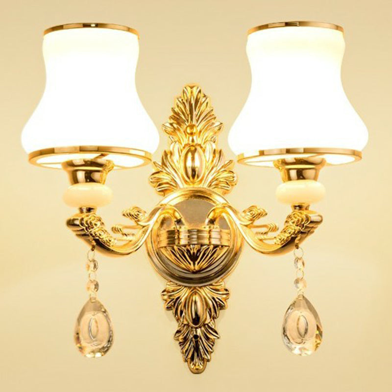 Close-up of shimmering crystal pendants on an ornate Victorian wall lamp. Luxurious traditional home accent.