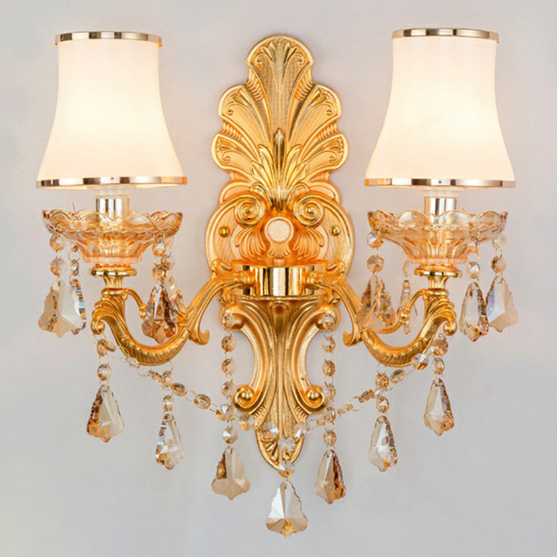 Ambient light from a sophisticated Victorian wall lamp, featuring a classic shade & ornate crystal accents.