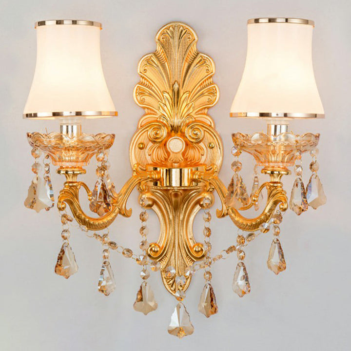 Ambient light from a sophisticated Victorian wall lamp, featuring a classic shade & ornate crystal accents.