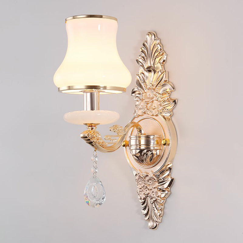 Elegant gold Victorian wall lamp mounted, featuring a classic shade & decorative crystal details for home accent.