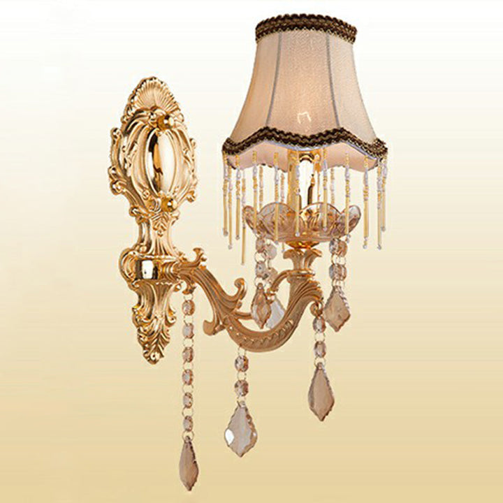 Ornate Victorian sconce with intricate gold metal scrollwork & sparkling crystal accents. Perfect elegant interiors.