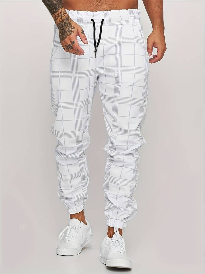 Relaxed fit men's checked joggers, perfect for sporty fashion, everyday comfort, and travel adventures.