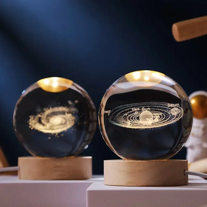 Luminous 3D Galaxy Engraved Crystal Ball LED Lamp on a natural wooden base. Perfect celestial decor.