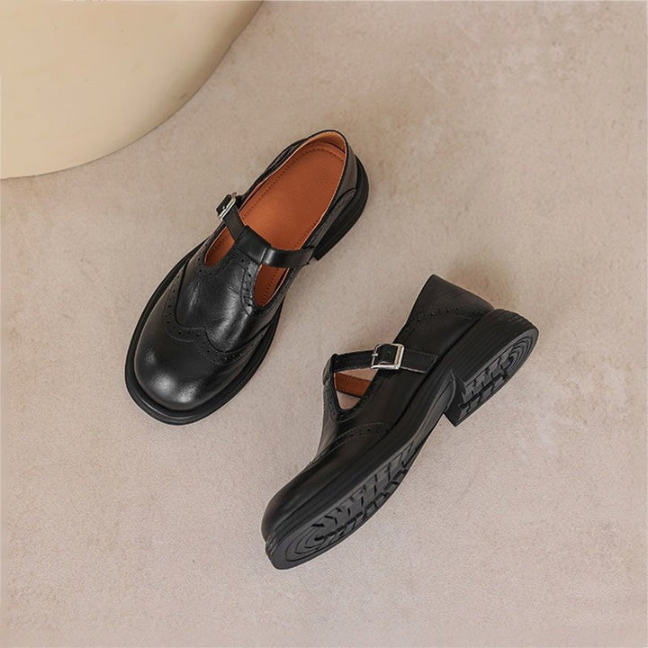 Women's elegant strap loafers, featuring a vintage-inspired design and comfortable flat sole for chic styling.