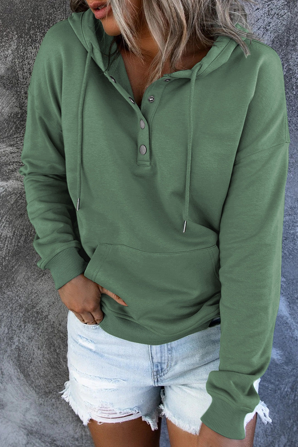 Women's cozy hooded sweater displayed on a hanger. Ready-to-wear everyday comfort.