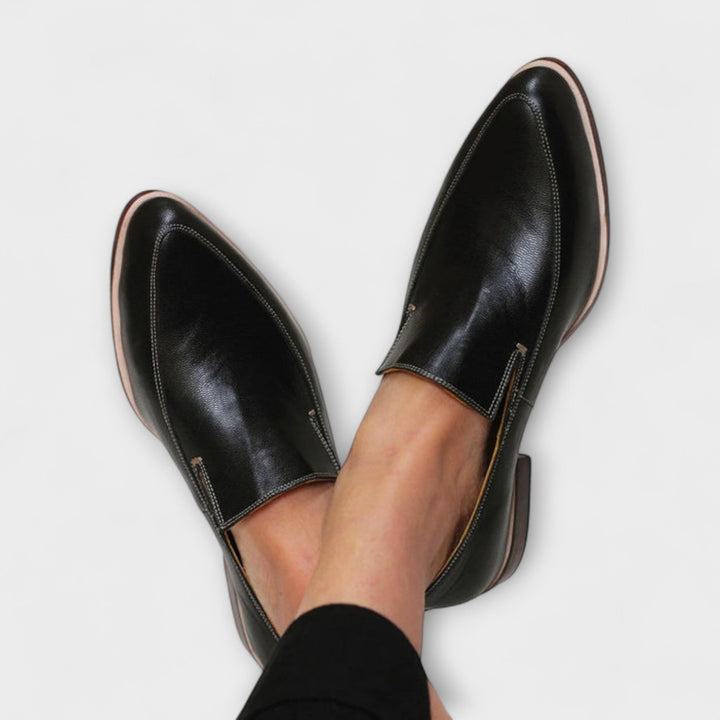 Black women's orthopaedic slip-on loafers for all-day comfort and foot support. Ideal for daily wear.