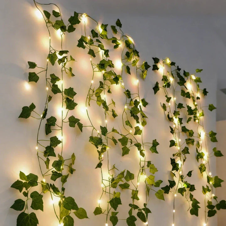 Battery operated LED vine lights with delicate warm white leaves for festive decor.