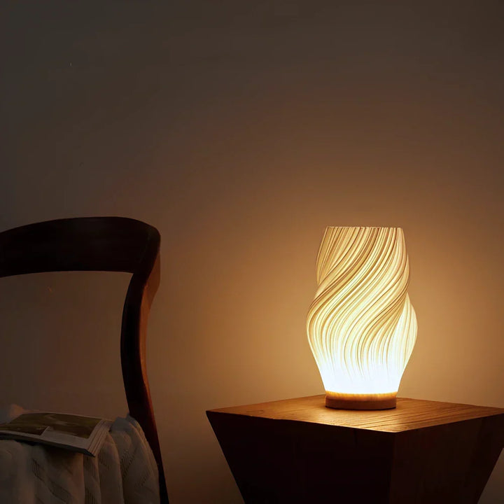 Contemporary sculpted lamp, Wavecrest design, provides natural light for any room.