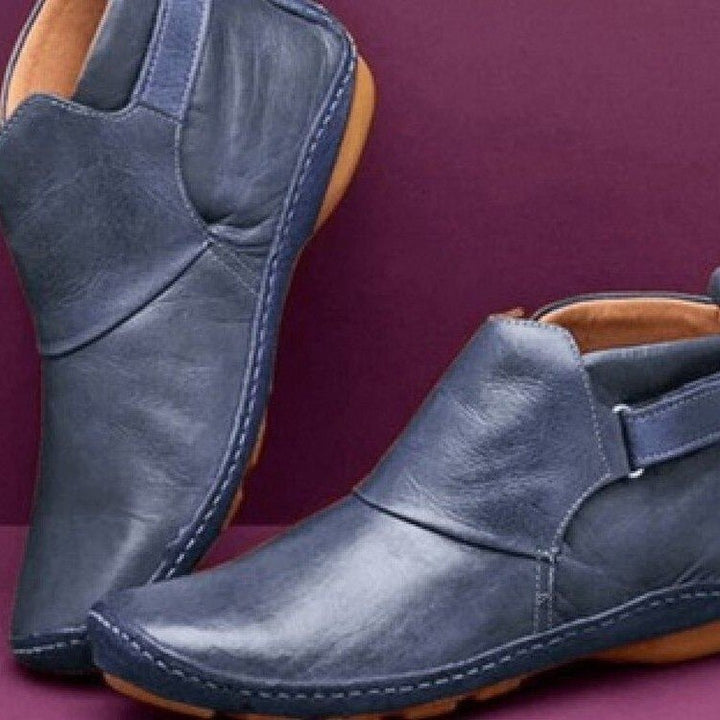 Chic women's pull-on ankle boots with adjustable strap, ideal for stylish fall & winter casual wear. Comfortable flat sole.