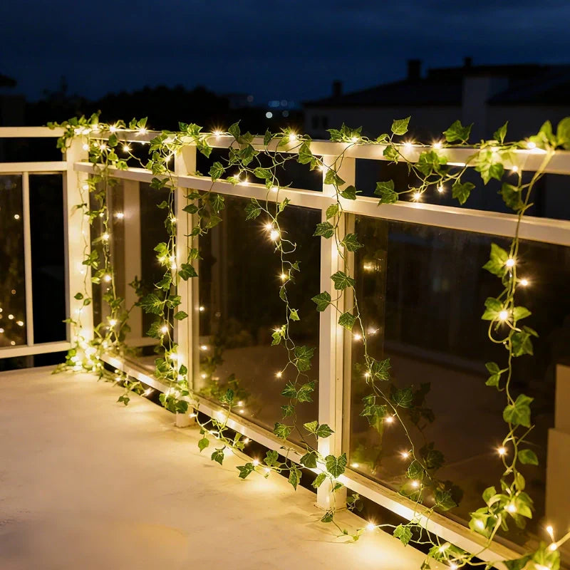 Charming LED vine string lights with warm white leaves, ideal for holiday & party decor.