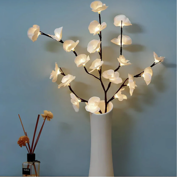 Floral home decor featuring warm white LED twig lights, creating a serene atmosphere.
