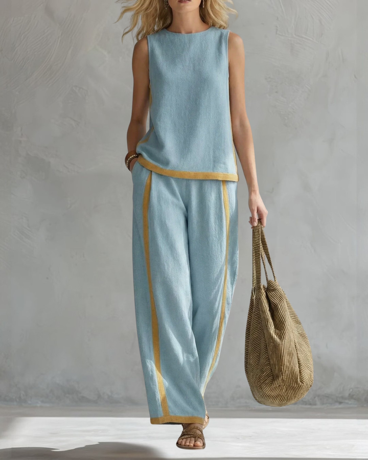 Women's elegant sleeveless top paired with flowy wide leg trousers in a chic two-piece set.