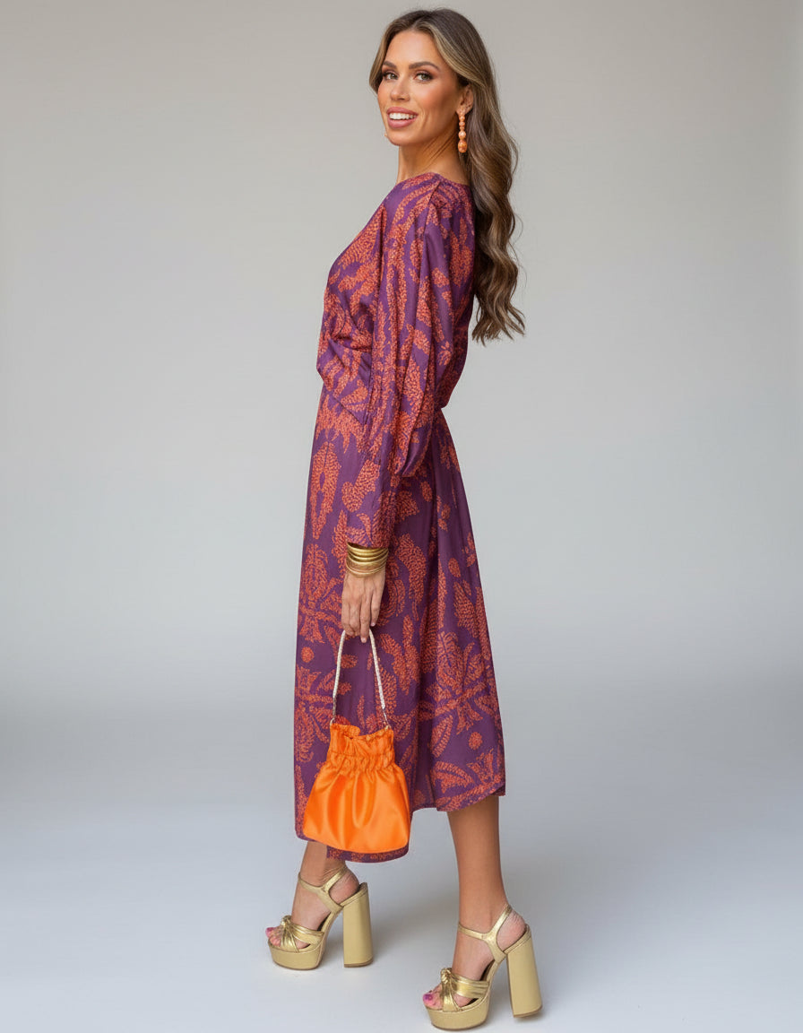 Close-up of the flowing fabric and unique pattern of this chic boho wrap dress, ideal for summer.