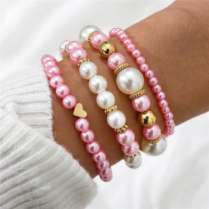 Elegant women's 4-piece faux pearl & heart beaded bracelet set. White layered fashion jewelry for her.