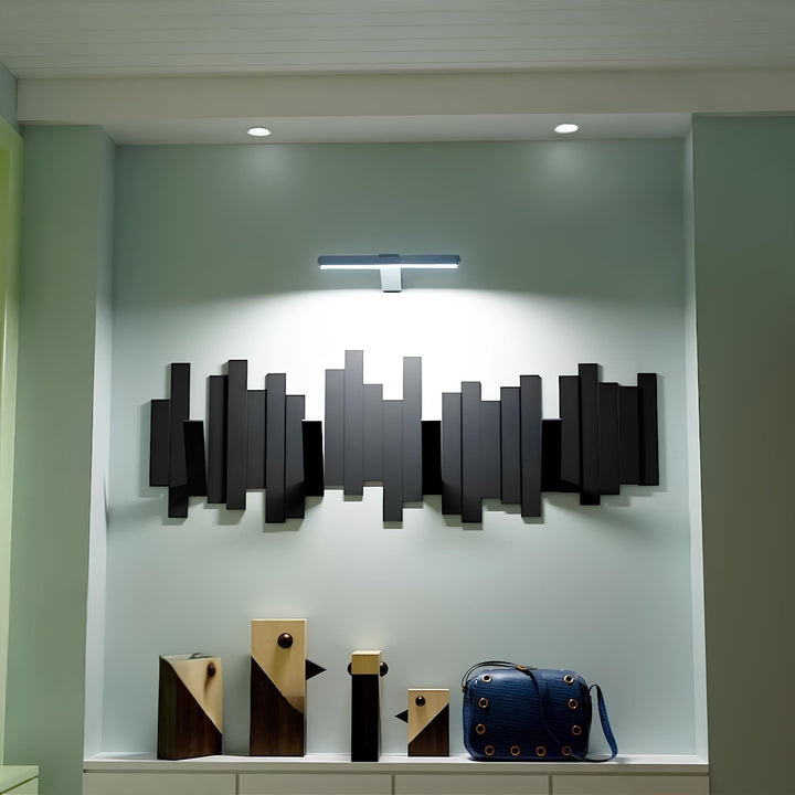 Wall-mounted wireless LED light for art, providing bright, focused illumination.