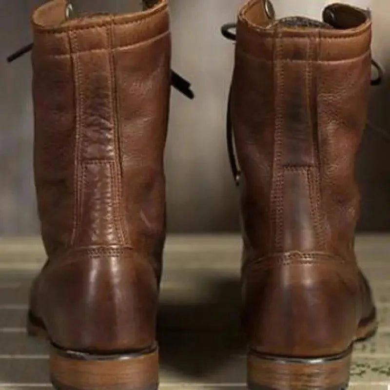 Side view of women's dark brown lace-up leather boots. Features round toe, comfortable fit, and sturdy block heel for casual wear.