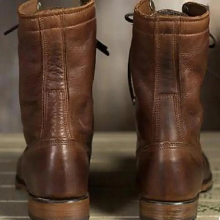 Side view of women's dark brown lace-up leather boots. Features round toe, comfortable fit, and sturdy block heel for casual wear.