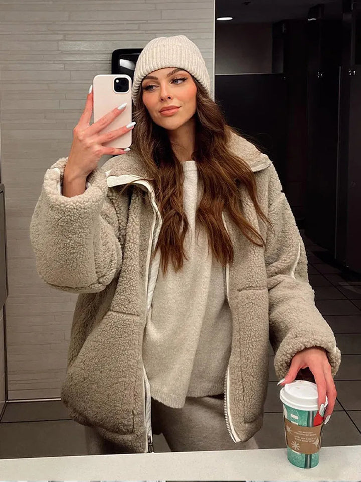 Stylish women's teddy jacket with a relaxed fit and full zipper. Fashionable and warm outerwear for winter layering.