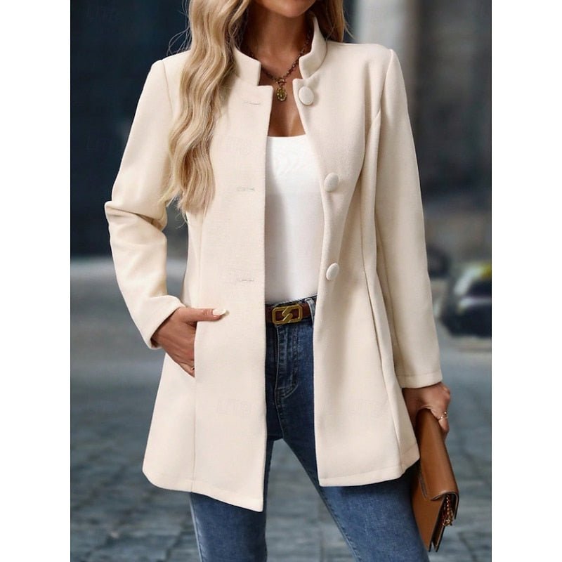 Women's elegant trench coat with stand collar and tailored fit, defining classic fall style.