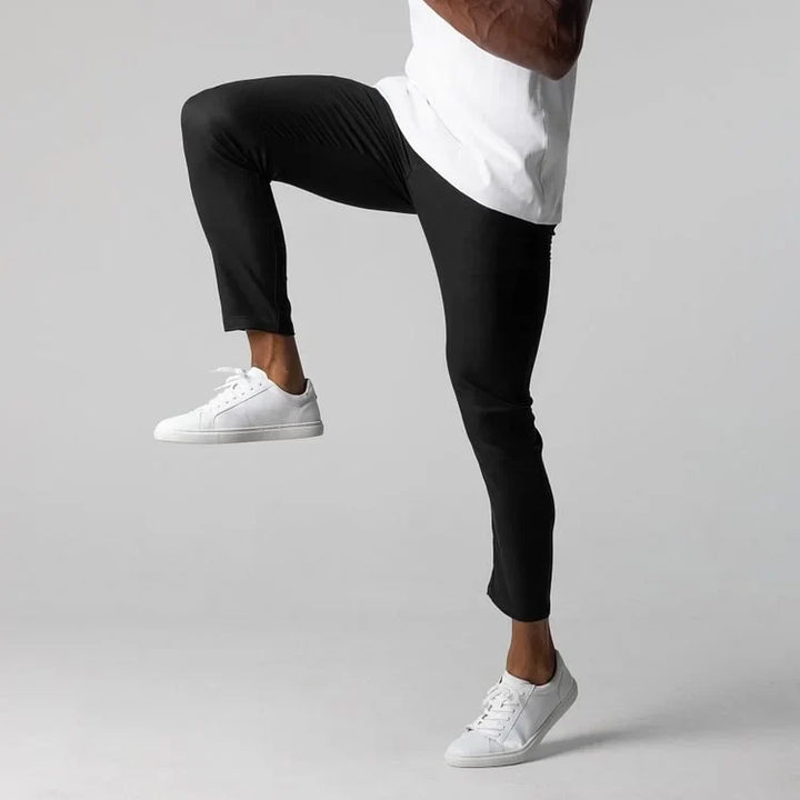 Grey men's activewear chinos, suitable for both gym and casual street style.