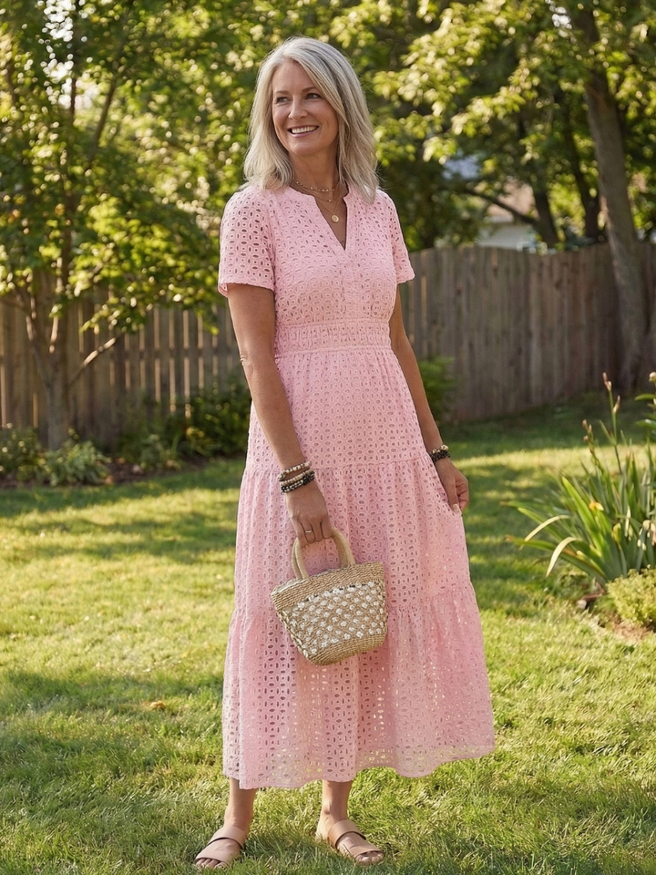 Front view of a white women's eyelet tiered midi dress with short sleeves, perfect for summer casual wear.