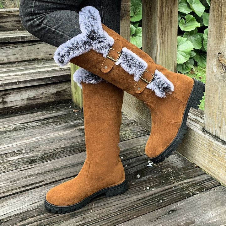 Black women's fur-trim knee-high boots with buckle details, round toe, for chic winter style.